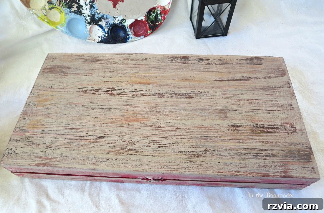 A top-down view of the finished DIY box, emphasizing the intricate textured paintwork and the overall aesthetic of aged wood. The subtle blending of colors and the distressed details are clearly visible from this angle.