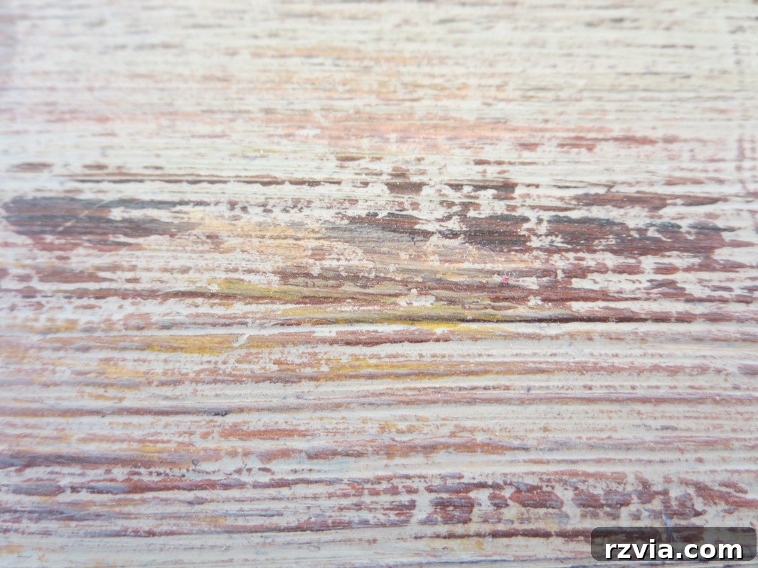 An extreme close-up of the painted laminate box, emphasizing the intricate textures and brushwork that create the illusion of aged wood. Every detail, from the varied paint application to the simulated grain, is highlighted, proving the effectiveness of the distressing technique.