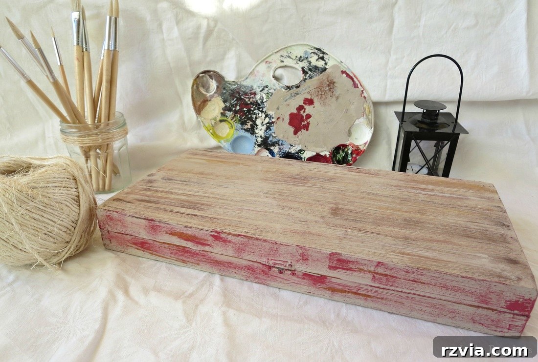 The completed DIY gift box, showcasing its rustic, aged wood finish with subtle red accents. The box is closed, presenting its transformed exterior, ready to be filled with gifts. This image highlights the successful makeover.