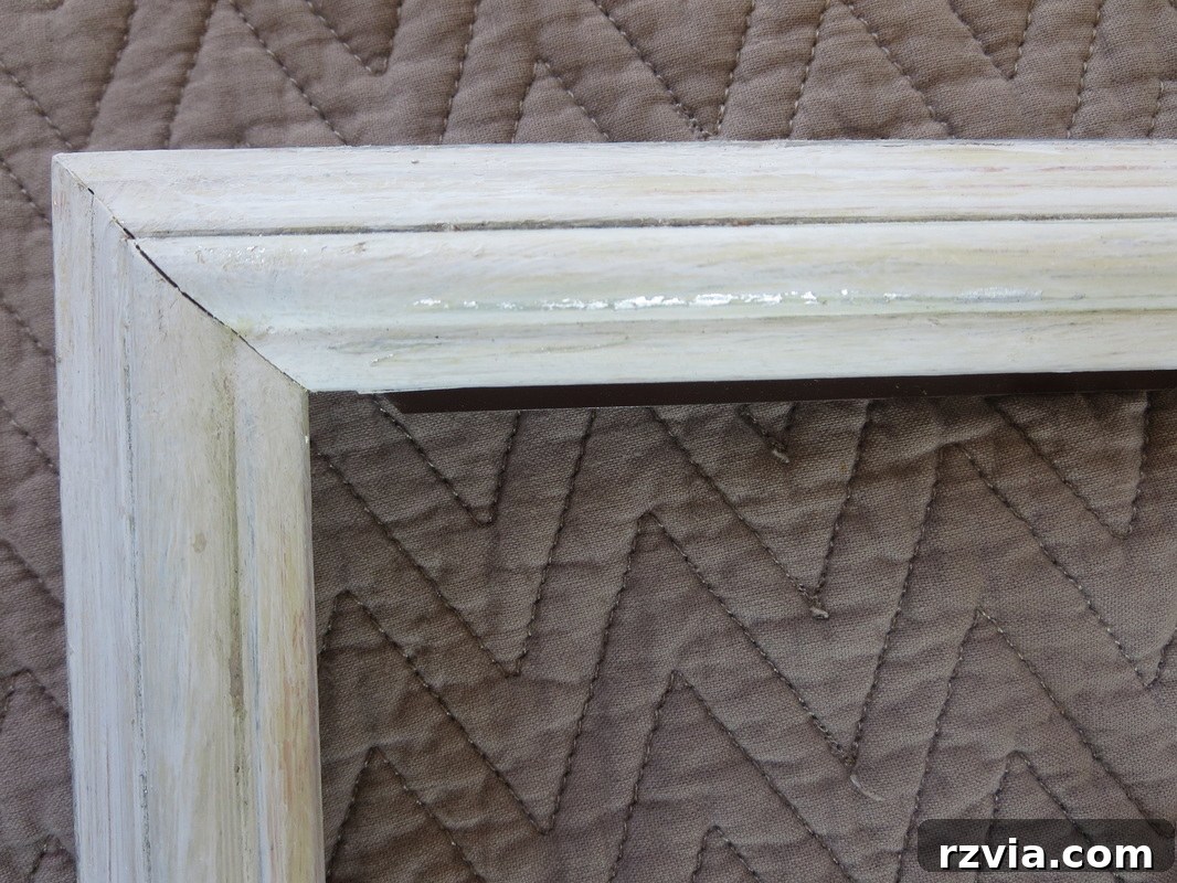 A close-up showcasing the beautiful distressed look achieved by gently abrading the paint, revealing subtle hints of the original metallic finish underneath the white paint.