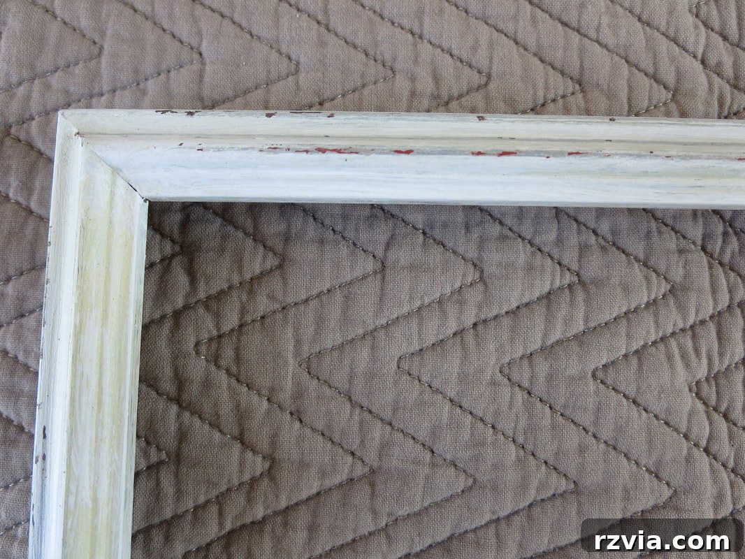 Another angle highlighting the 'peeking through' effect where the original frame color subtly appears through the distressed white paint, adding character.