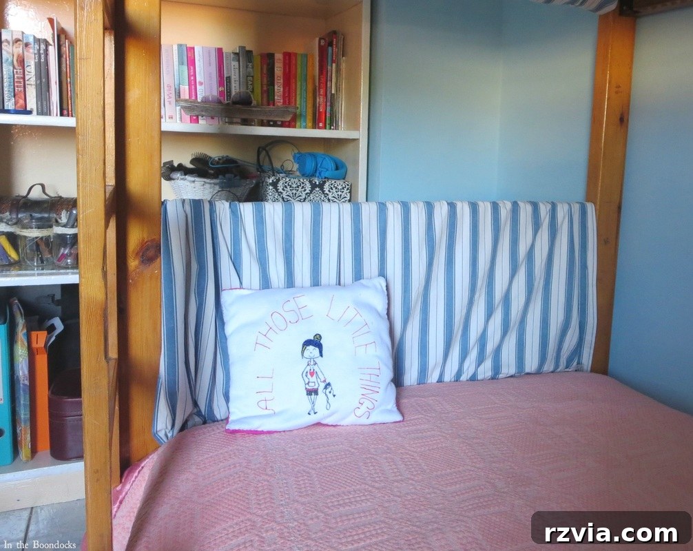 Repurposed Chic: A Teen Girl's Unique Bedroom Makeover 5 Adding blue striped fabric to a bunk bed to soften its appearance, a smart upcycling idea for a teen bedroom.