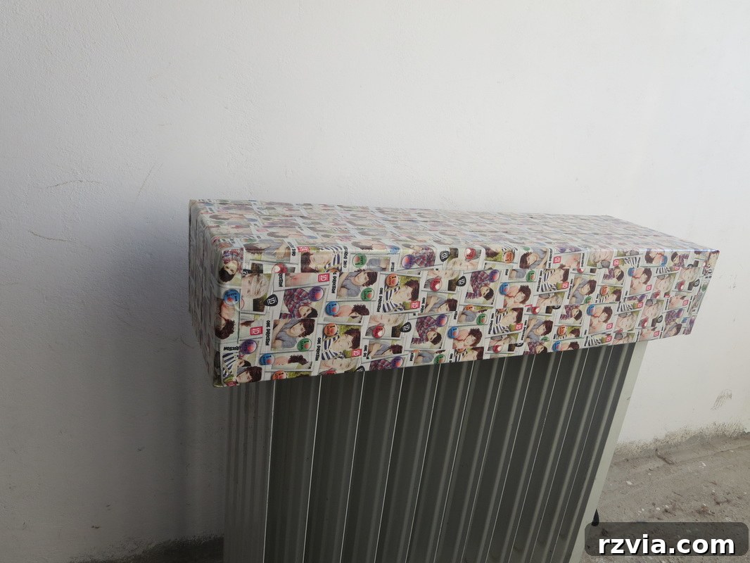 Finished Washi tape cardboard heater cover, now a stable bedside shelf. Hiding under the wrong direction www.theboondocksblog.com