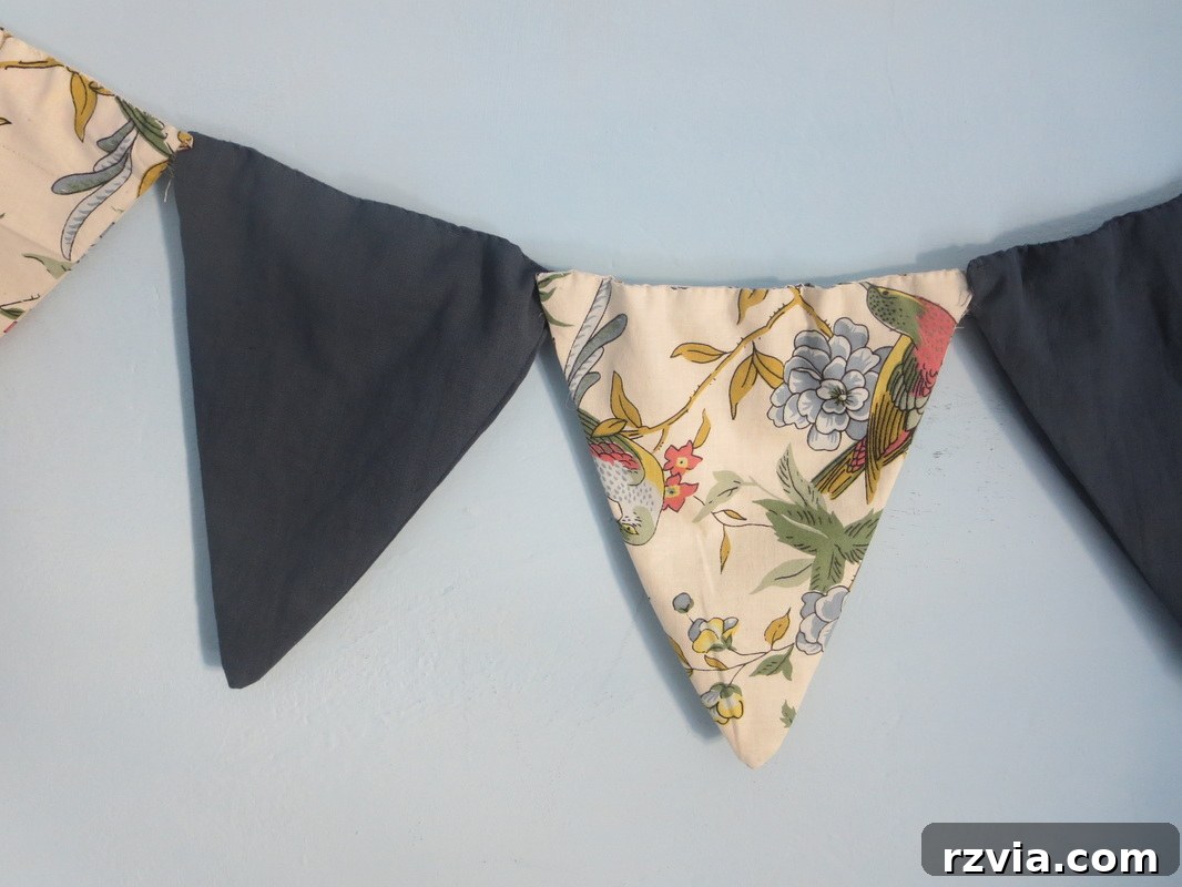 Close-up view of the completed DIY fabric banner, showcasing the beautiful patterns and textures of the repurposed textiles, adding a charming touch to the blue room decor. Ideal for inspiring creative upcycling projects.