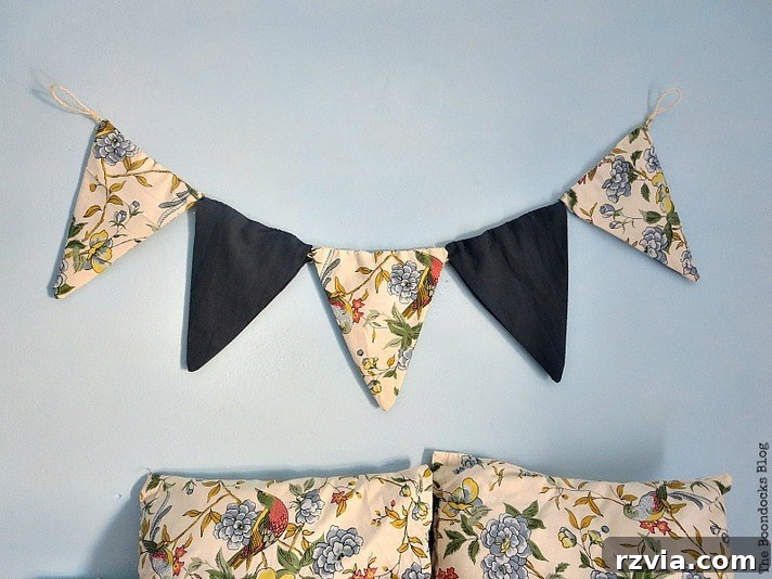 Full view of the blue room featuring the DIY fabric banner and coordinated pillows, showcasing how repurposed textiles can create unique and harmonious children's room decor. Inspiring ideas for budget-friendly interior design.