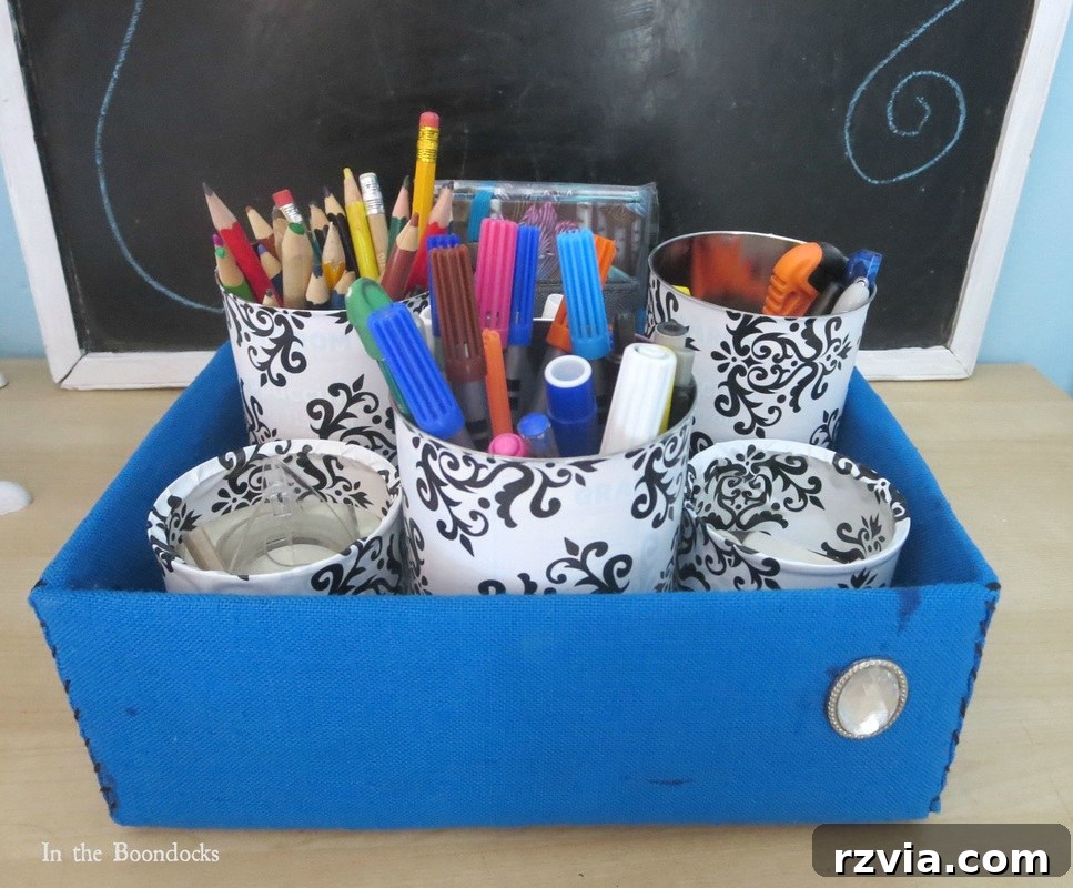 After image of a desk organizer featuring stylish black and white patterned tin cans, showcasing vastly improved aesthetics and organization.