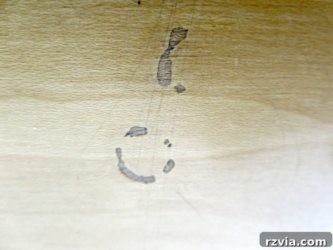 Painted Paper Dresser Revival 5 Detailed view of scratches and wear on the dresser, illustrating its long history of use and the urgent need for a refreshing DIY makeover. www.theboondocksblog.com