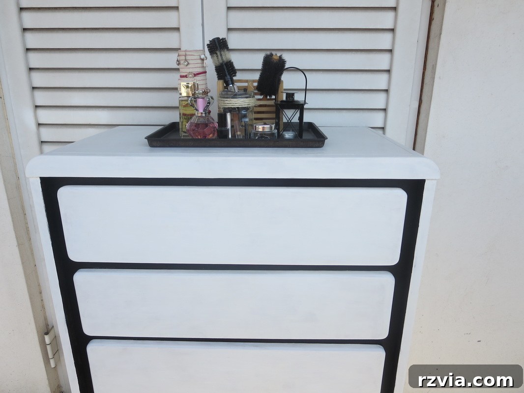Painted Paper Dresser Revival 10 Strategic application of black paint on the dresser, creating a striking contrast and adding definition to its features. www.theboondocksblog.com