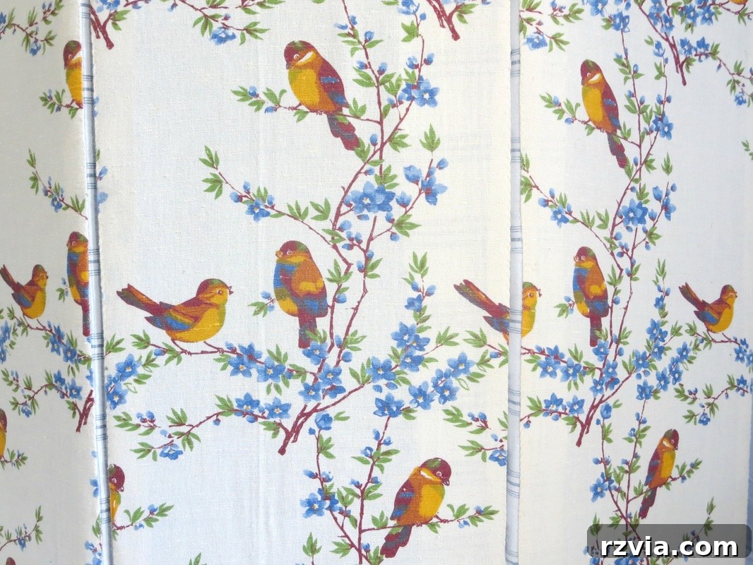Applying batting and a beautiful bird pattern fabric to laminate board panels for a custom partition