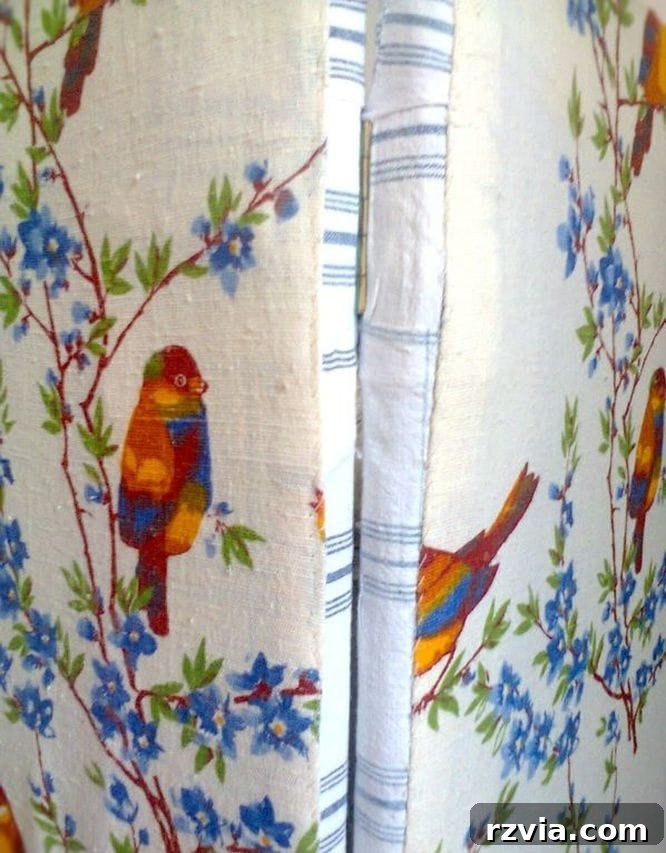 Close-up of hinges and brackets securing the fabric-covered laminate boards together