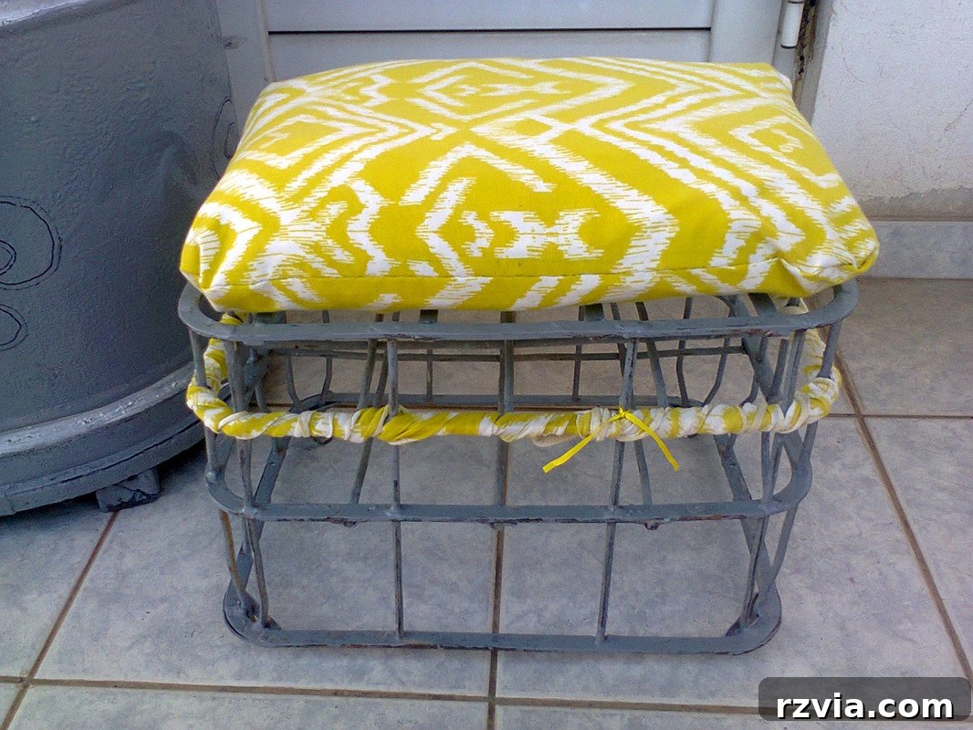 Relocating the fabric scraps higher up on the milk crate stool to refine its decorative appearance. An example of iterative design in DIY projects.