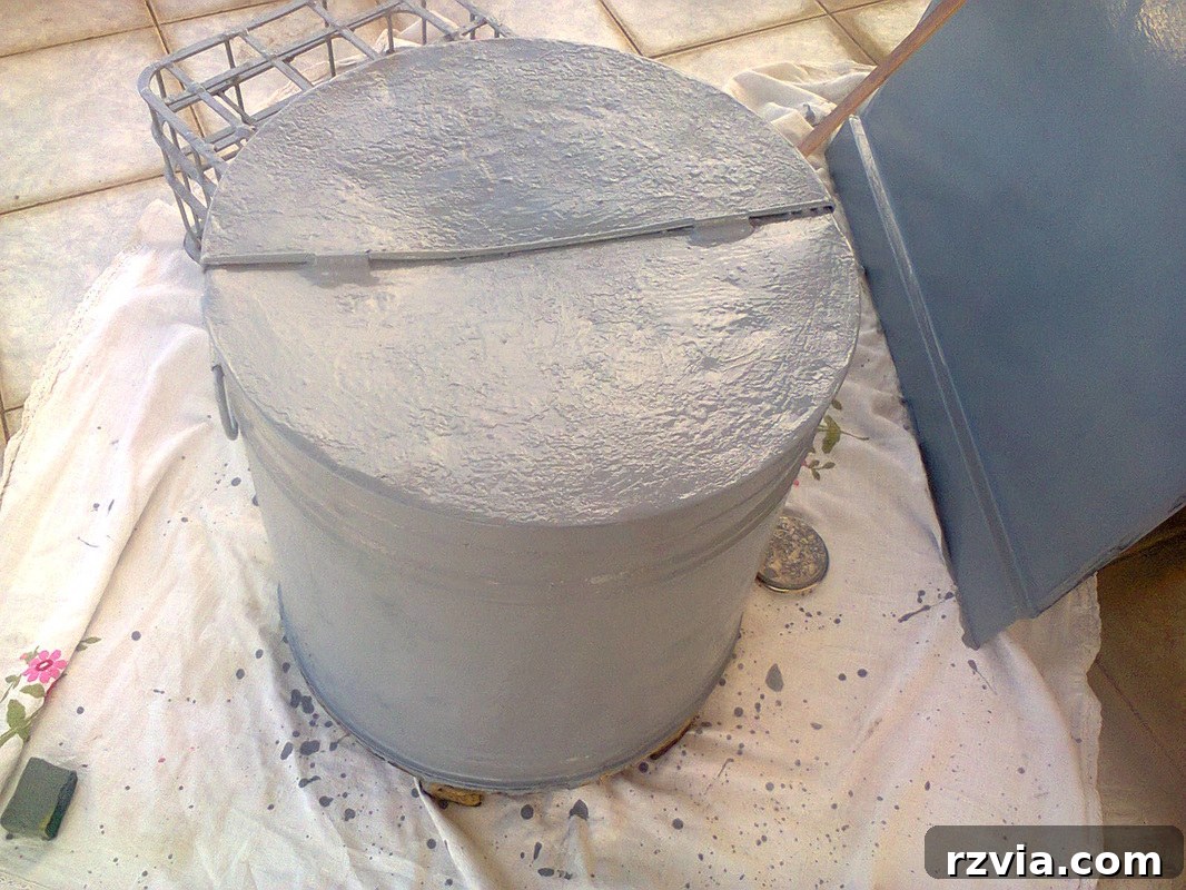 Painting the olive oil barrel in a neutral grey color