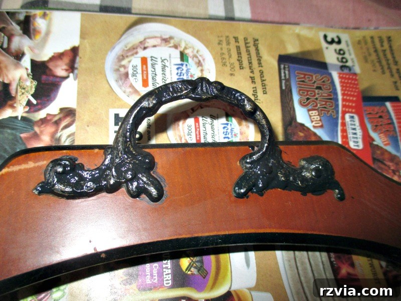 Reimagining a Vintage Serving Tray 5 Close up view of one of the metal handles painted black.