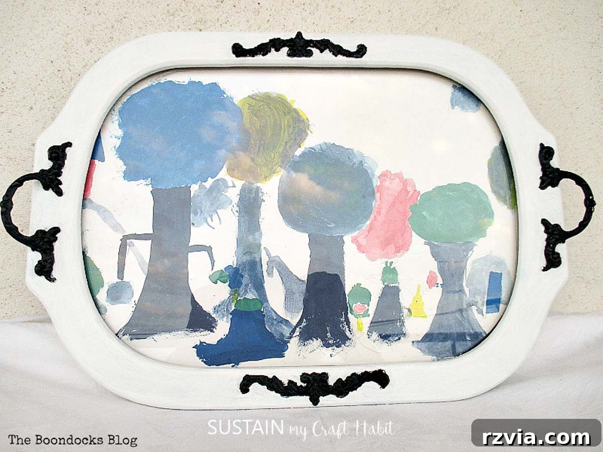 Reimagining a Vintage Serving Tray 7 Completed upcycled serving platter with a child's painting of trees mounted behind the glass.