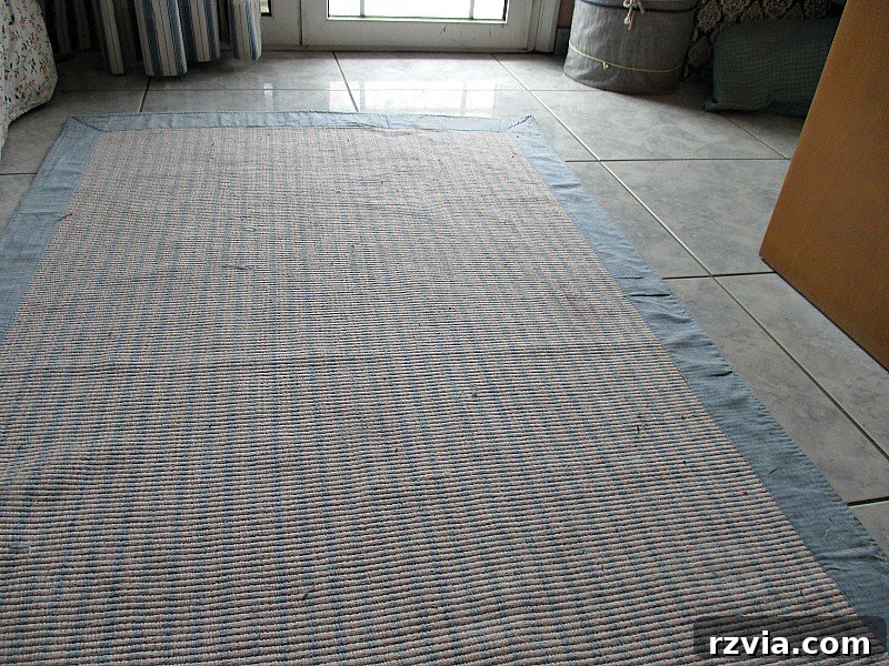 A close-up view of the rug after successful fabric paint repair, showing no trace of the stain.