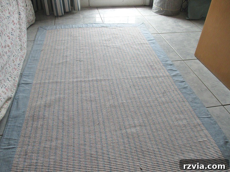 A full view of the white and blue rug, now completely repaired and looking new after the stain fix.