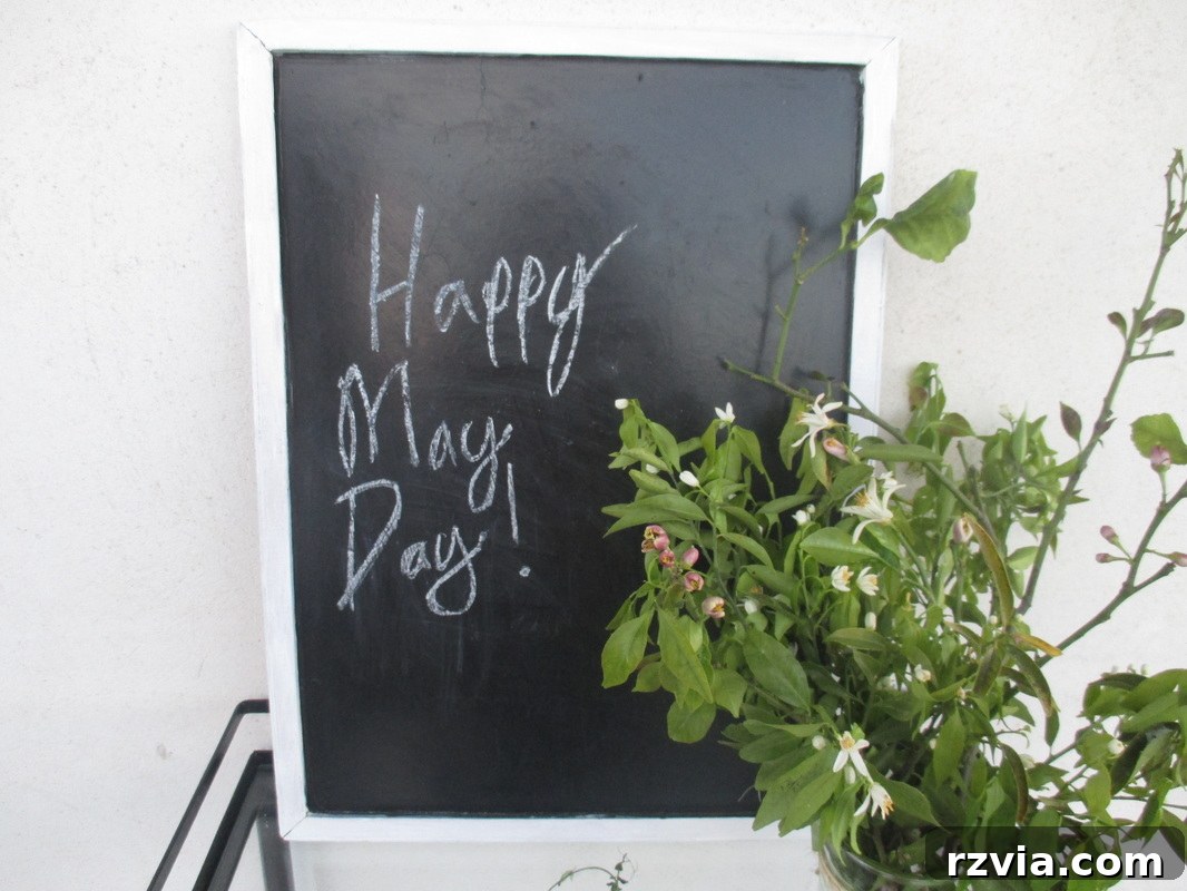 Blackboard on a rustic table adorned with spring flowers, celebrating May Day with The Boondocks Blog