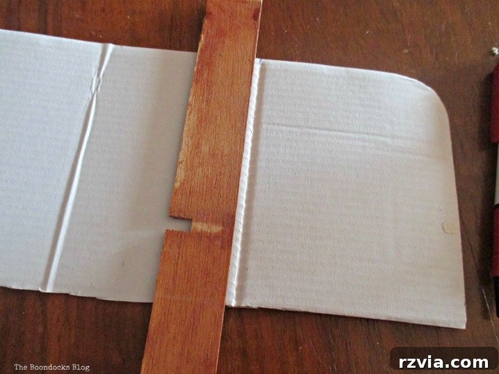 From Clutter to Clever Upcycled Cable Organizers 9 Cardboard piece scored and folded into sections for wire organizer dividers