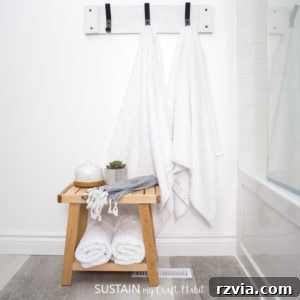 White-washed pallet wood towel rack for a rustic bathroom