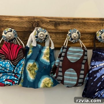 Upcycled pallet and doorknob face mask organizer for entryway