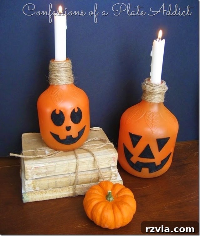 Plastic juice bottles upcycled into charming Jack O' Lantern candlesticks by Confessions of a Plate Addict.