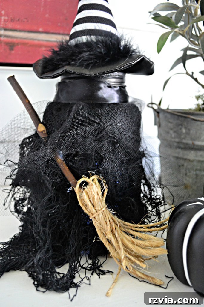 Creative witch decoration made from a surprising household item by Red Cottage Chronicles.