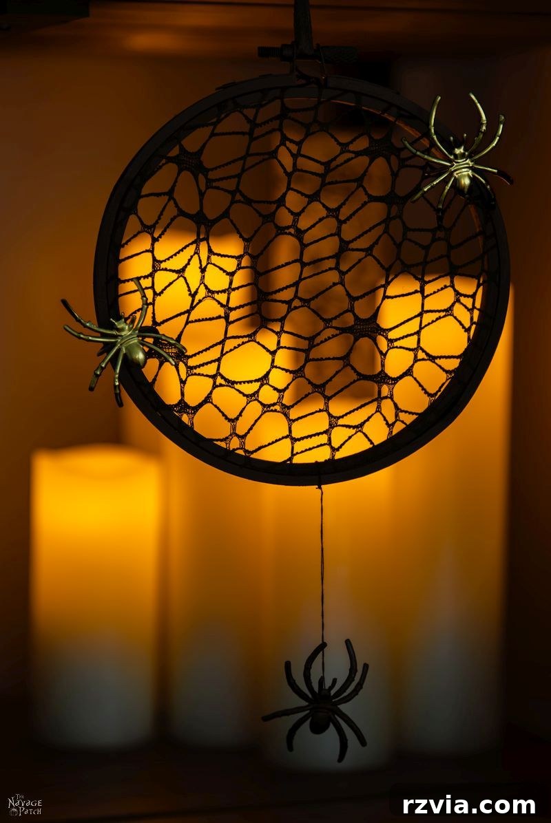 Creepy spider web wreath crafted from an embroidery hoop by The Navage Patch, perfect for Halloween.