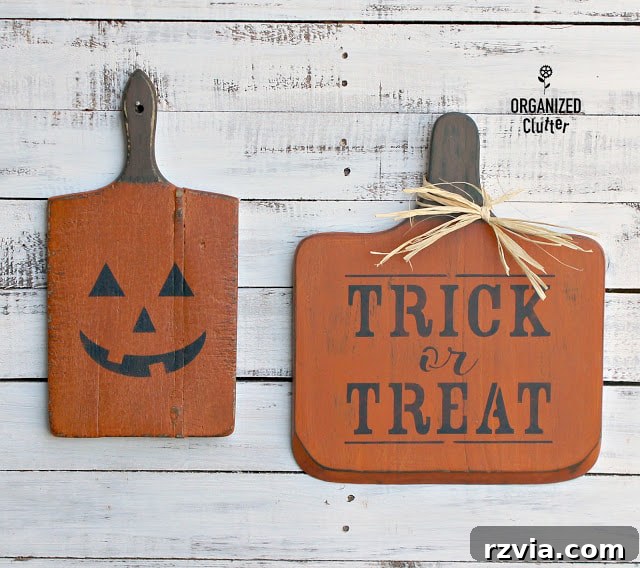 Upcycled cutting boards transformed into festive Halloween signs by Organized Clutter.