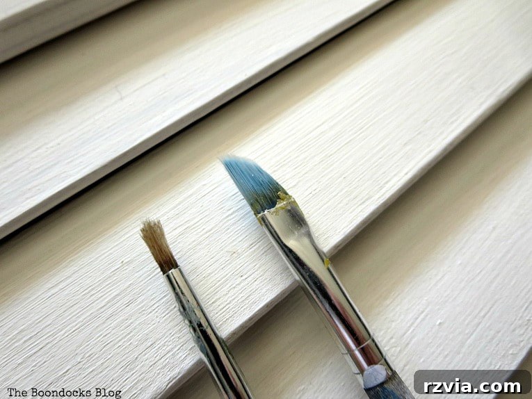 Unconventional Shutter Stenciling Secrets 10 Switching to finer brushes for the second stenciling attempt on the shutter, hoping for better control over the metallic paint on the uneven slats. Discover if this change in tools made a difference.