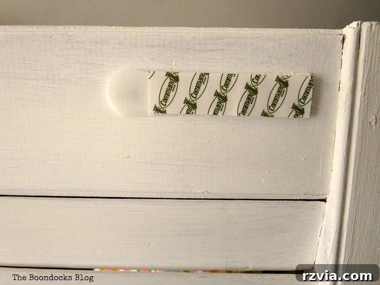 Unconventional Shutter Stenciling Secrets 17 Attaching Command Strips to the back of the finished stenciled shutter for easy, damage-free hanging as unique wall art. Learn how to securely display your DIY creations.