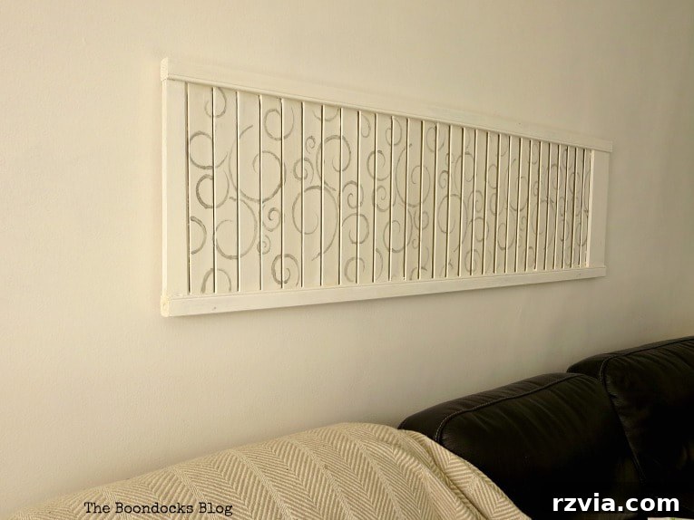 Unconventional Shutter Stenciling Secrets 20 The subtly elegant stenciled shutter art positioned above the sofa, complementing the overall room decor without overpowering it. This DIY piece provides presence and character in a balanced way. #shutterart #stenciledshutter #chalkyfinishpaint #DecoArtMedia #DIYArt #Stenciledswirls