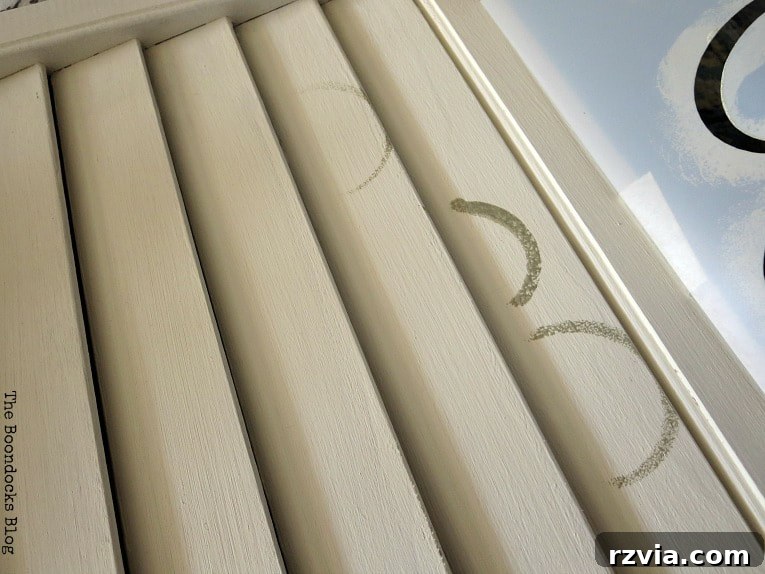 Unconventional Shutter Stenciling Secrets 9 The disappointing outcome of the first stenciling attempt on the shutter, showing paint bleeding and uneven application due to the slats. A lesson in adapting techniques for textured surfaces.