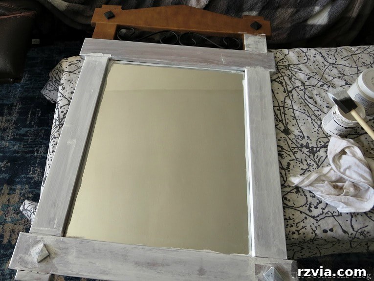 Effortless Side Mirror Refresh 4 Applying the first coat of white chalky finish paint to the wood mirror frame, a crucial step in this easy DIY mirror makeover.