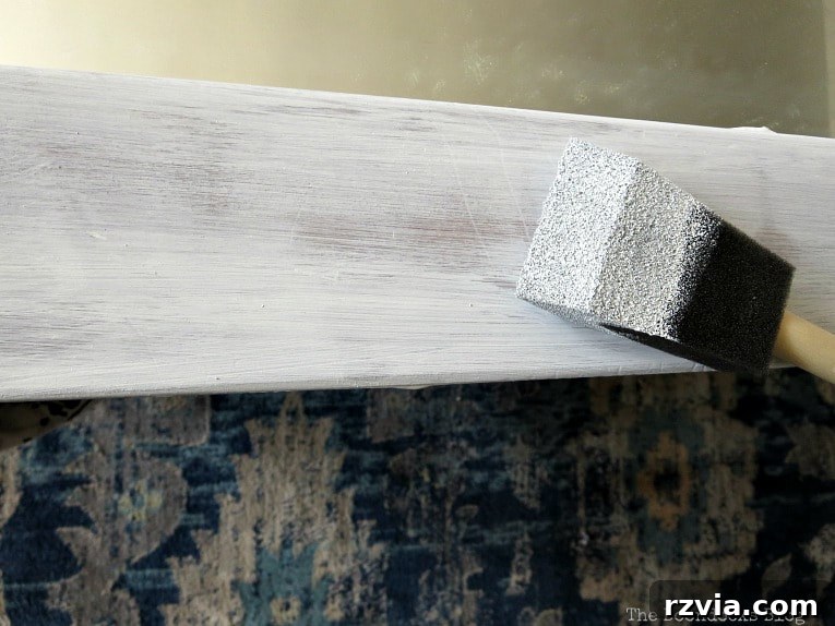 Effortless Side Mirror Refresh 5 A close-up showing unwanted streaks on the mirror frame, a result of using a sponge brush for chalky paint. Learn from this mistake for a smoother finish.