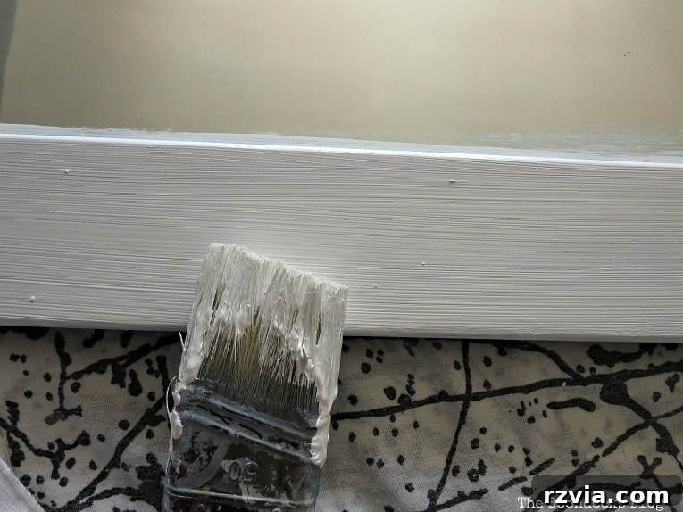 Effortless Side Mirror Refresh 6 Applying the second coat of chalky finish paint with a bristle brush for a smooth, even application on the vintage mirror frame. A crucial step for a professional-looking makeover.