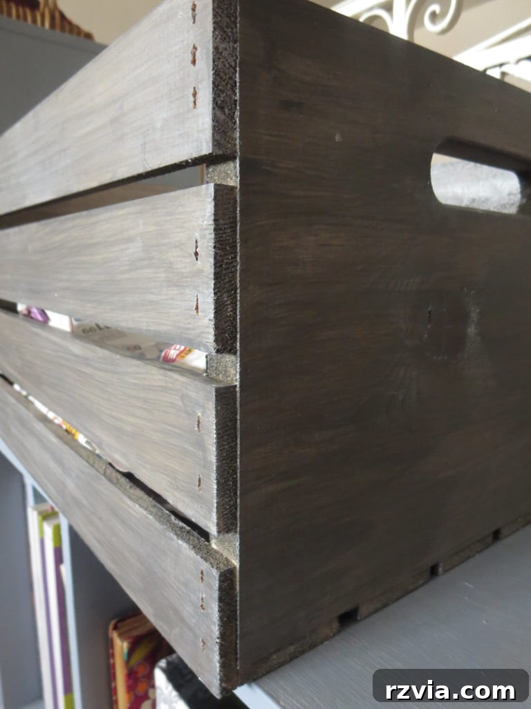 Barnwood Gray stained wooden crate, highlighting the rustic, farmhouse aesthetic. Perfect for easy DIY home decor and upcycling projects. Learn how to achieve a stunning wood crate finish with stain and wax at www.theboondocksblog.com.