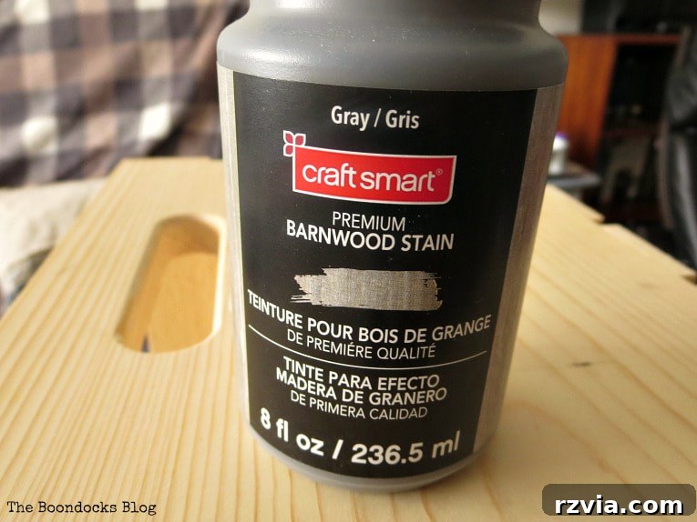 Close-up of a bottle of Craft Smart Premium Barnwood Stain in Gray, essential for achieving a rustic wood finish.