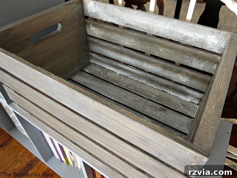 The interior of the wooden crate revealing a charming, rustic texture enhanced by white wax, due to intentional unsanded wood.