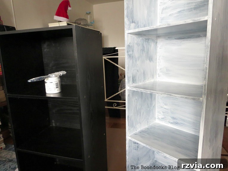 Effortless Cubby Storage Refresh 4 Applying the first coat of paint to a black cubby storage unit