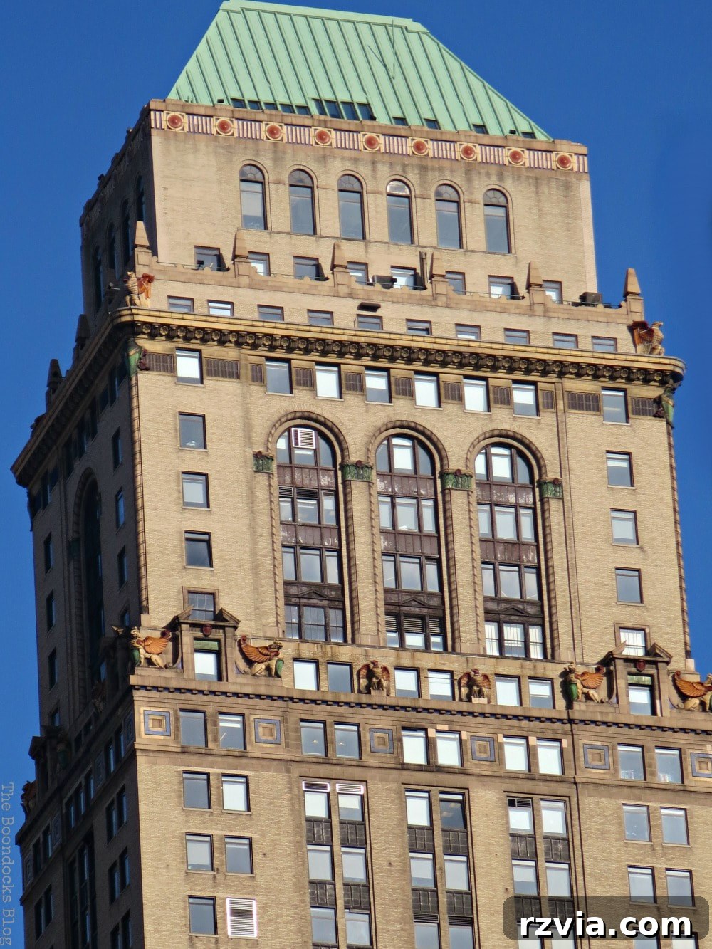 An ornate historical building in Midtown Manhattan, New York, showcasing intricate architectural details amidst modern structures.