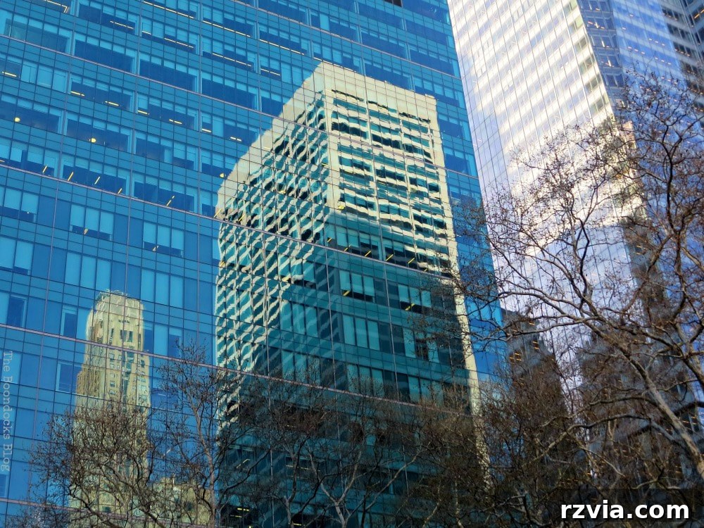 Buildings and sky reflected beautifully on the shimmering glass facade of a modern skyscraper, offering a unique visual perspective.