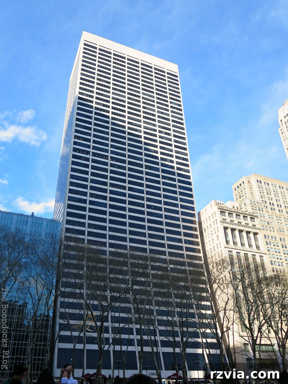 The distinctive W.R. Grace Building on the North side of Bryant Park, New York, with its famous curved facade seemingly leaning.