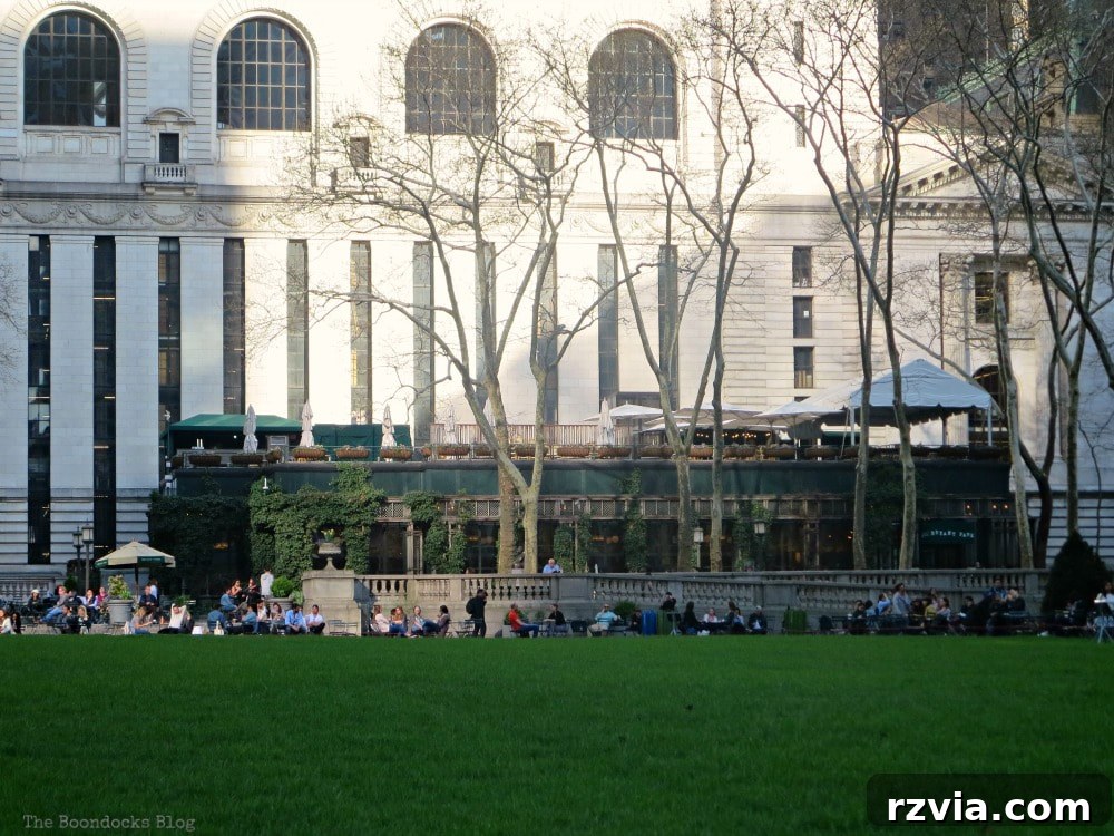 The backside of the New York Public Library building, featuring the Bryant Park Grill with its outdoor seating, offering a scenic dining experience.