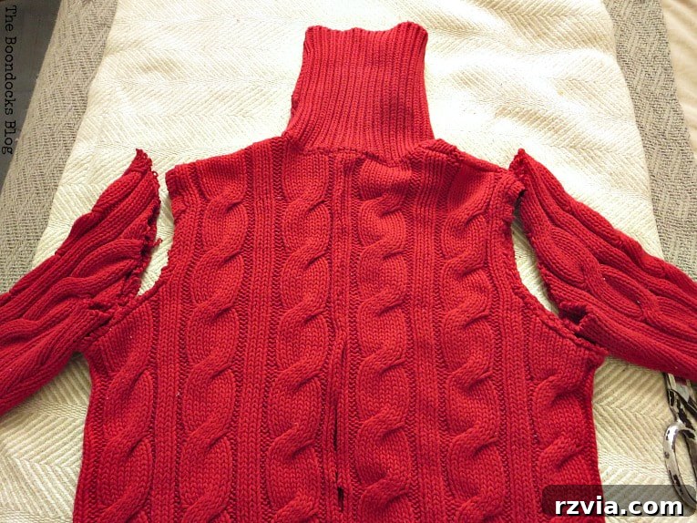 Repurpose Old Sweaters into Christmas Stockings 3 Cutting the sleeves off an old sweater to begin the Christmas stocking project.