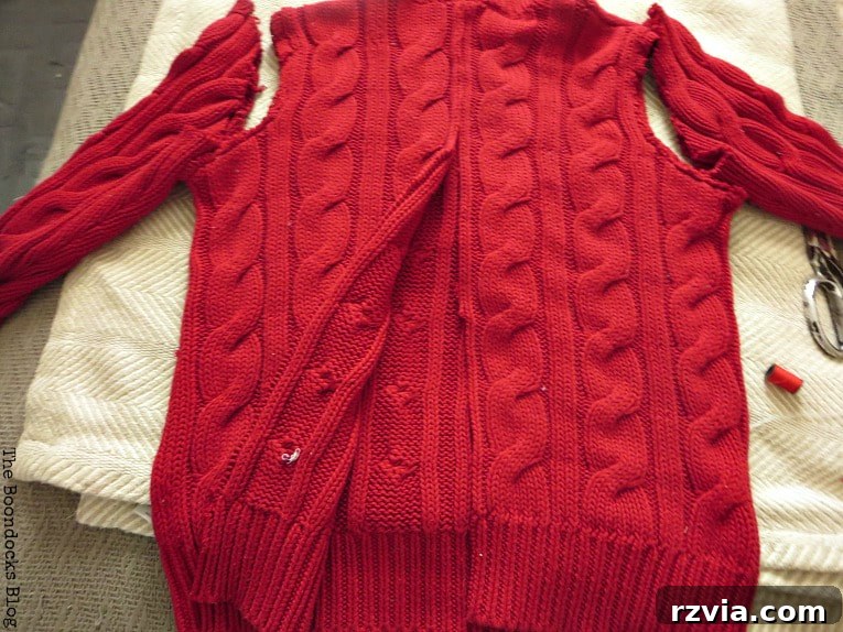 Repurpose Old Sweaters into Christmas Stockings 4 Cutting the main body of the sweater in half down the center seam.