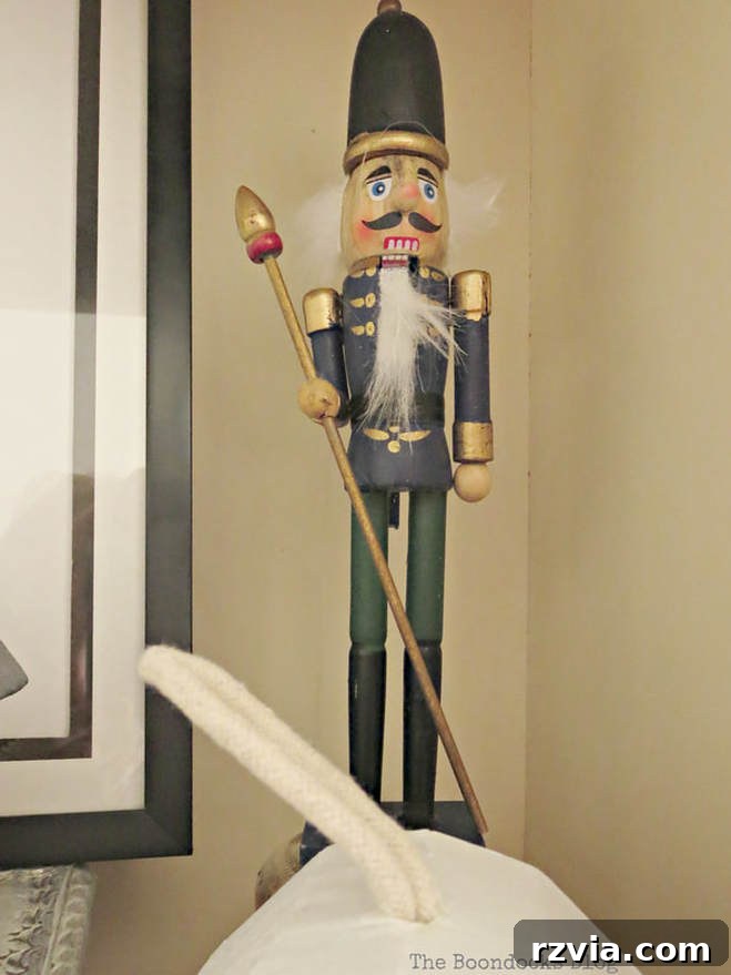 Repurpose Old Decor for Stunning Christmas Vignettes 15 The classic Nutcracker figure, a beloved holiday decoration, adding a touch of traditional charm to a Christmas vignette.