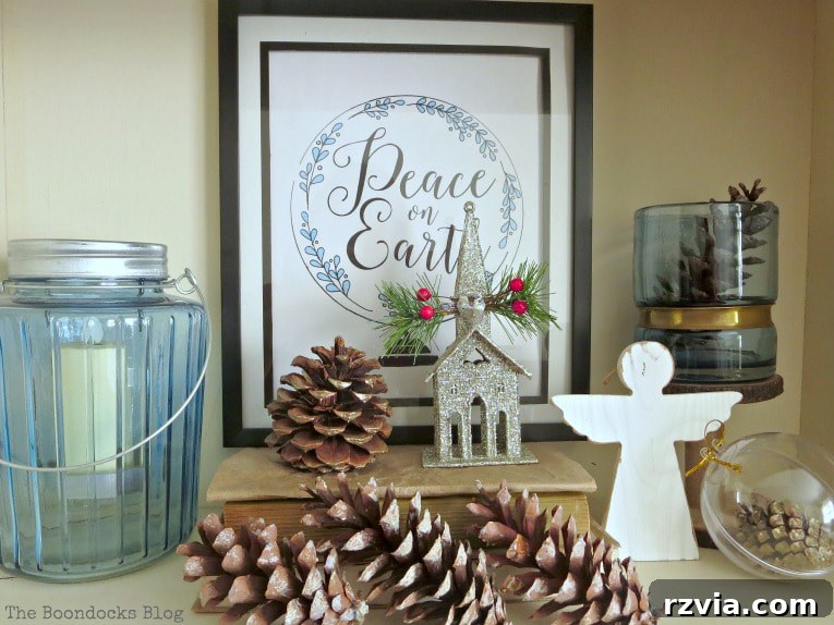 Repurpose Old Decor for Stunning Christmas Vignettes 3 A blue and white themed Christmas vignette featuring a framed printable and various decorative items, highlighting a sophisticated holiday decor approach.