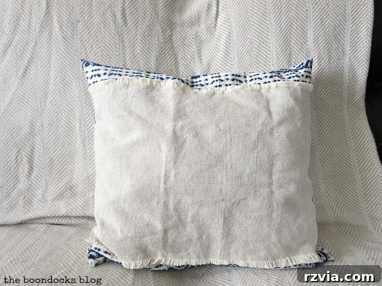 Upcycle Your Fabric Scraps: 5 Easy Pillow Projects 17 Finished upcycled pillow, showcasing the rustic linen side with frayed ends, exuding a boho aesthetic.