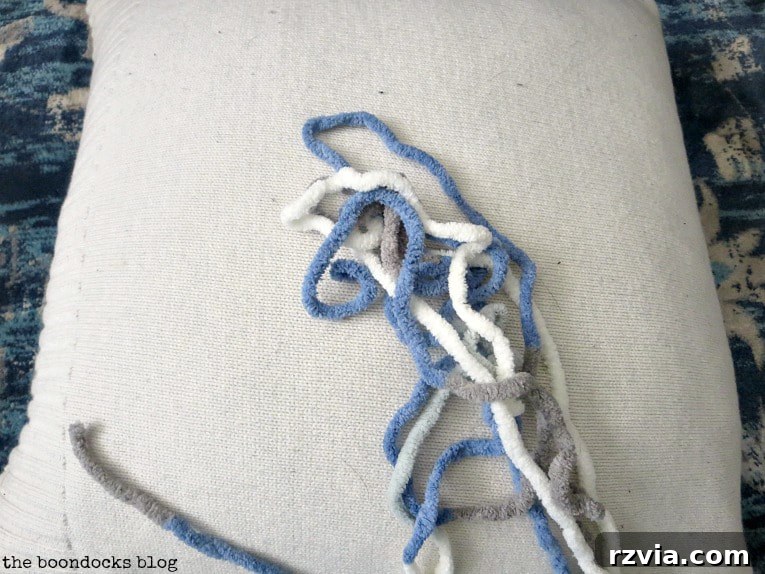 Upcycle Your Fabric Scraps: 5 Easy Pillow Projects 9 Soft pillow made from an upcycled sweater, demonstrating creative fabric reuse for home decor.