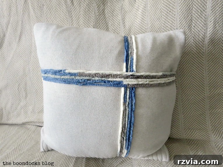 Upcycle Your Fabric Scraps: 5 Easy Pillow Projects 10 Sweater pillow adorned with a decorative yarn ribbon, showcasing a festive and upcycled design.